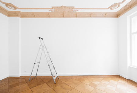 ladder in empty room with white wall and wooden floorの写真素材