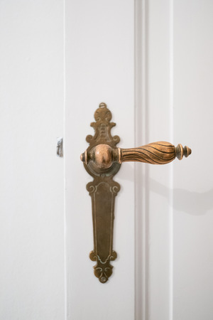 beautiful old door handle on white doorの写真素材