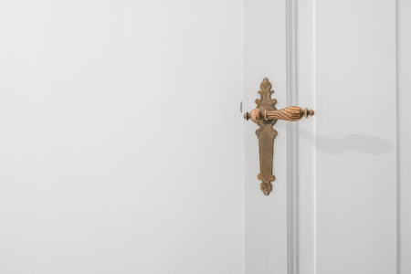 beautiful old door handle on white doorの写真素材