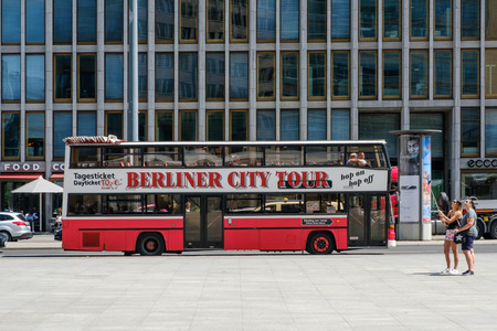 Berlin, Germany - june 9, 2017: A sightseeing bus offering Berlin City Tours with two tourists...