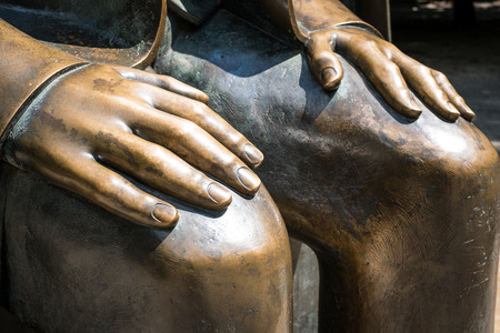 hands on knees sculpture - bronze statue,の写真素材