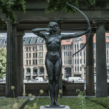 Statue of a naked woman with archの写真素材