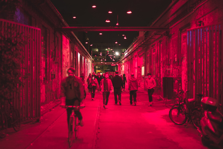 people walking on street at night in nightlife area - blurred