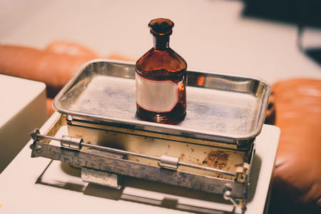 old empty medicine bottle on scale - vintage look