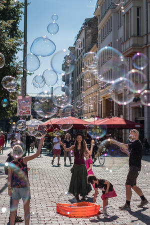 Berlin, Germany . August 29, 2017 : Girl making soap bubbles on a sunny day on the street in Berlin, Germany.のeditorial素材