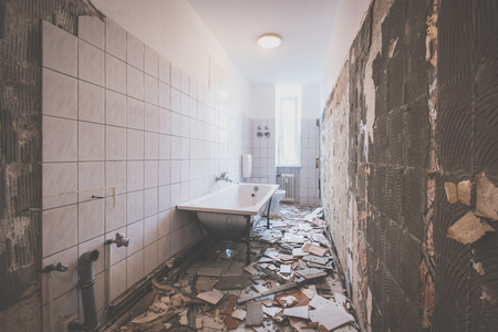 Bathroom renovation - removing tiles in old apartment bathroom -の写真素材