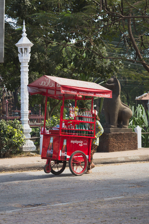 street vendor / man with old coca cola cart sells drinks on streetのeditorial素材