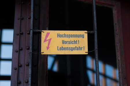 Electricity warning sign with flash symbol and german text: Hochspannung Vorsicht Lebensgefahr ( High voltage, mortal danger)の写真素材