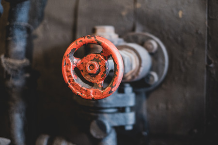 vintage red valve handle closeup - old  technologyの写真素材