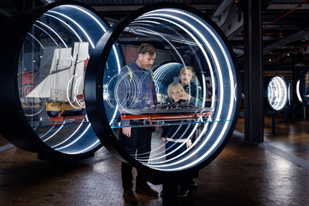 Visitors at the German Museum of Technology looking at ship model at naval exhibition.のeditorial素材