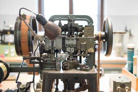 Berlin, Germany - February 2018: Anchor chain prosuction machine at German Museum of Technology (Deutsches Technikmuseum) looking at ship model at naval exhibition.のeditorial素材