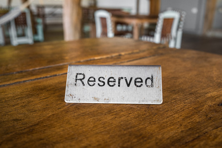 reserved sign on table in restaurant closeup - vintage styleの写真素材