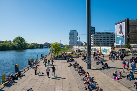 Many People at River Spree at Berlin Wall (East Side Gallery) on a sunny day in Berlin, Germanyのeditorial素材