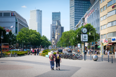 Two traveler with backpacks on Berlin`s famous shopping avenue Kurfuerstendamm aka Kudamm in Berlin, Germanyのeditorial素材