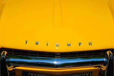 Triumph classic car engine hood closeup with brand name / logo letteringのeditorial素材