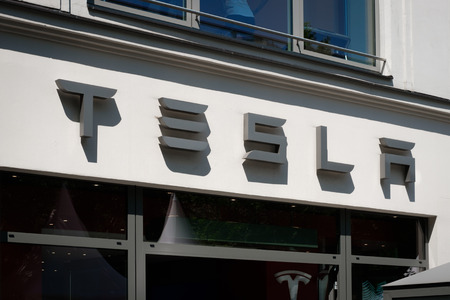 Tesla logo / brand name on shop facade in Berlin. Tesla, Inc. is an American multinational...