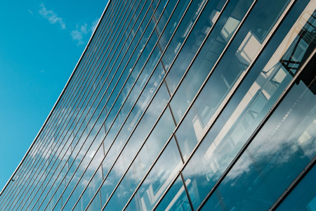 glass facade of modern office building and blue sky