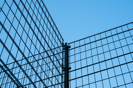 metal fence on blue sky -  metal grid construction -