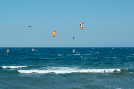 Many kite board surfers and wind surfers on ocean El Medano beach, Tenerifeの写真素材