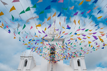 white church on blue sky with  colorful holiday decorationの写真素材