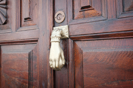 old knocking door knob on wooden door closeup