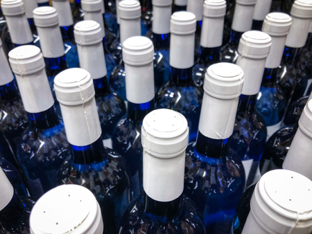 wine bottles - many blue bottes with white label / bottlenecksの写真素材