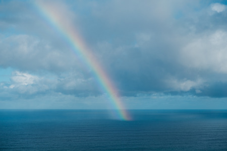 rainbow on ocean, rainbow ending on ocean