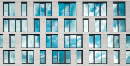 modern office building facade , window facade with sky reflection