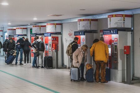 People with luggage buying ticket at vending machine near airport in Berlinのeditorial素材