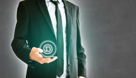 man holding mobile phone, businessman using smartphone for emailの写真素材