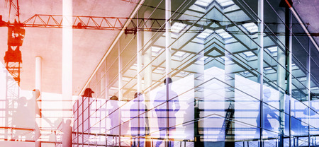 Crowd of business people working in office building over  cityscape double exposure -の写真素材