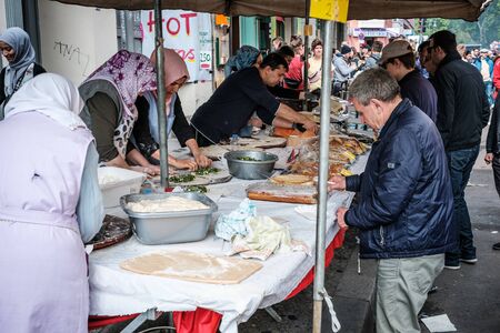 Women preparing food at street market at myfest, Labor Day Parade on May 1st, Berlin, Kreuzbergのeditorial素材