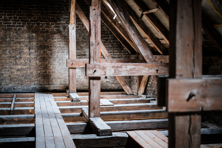 roof beams in old, empty attic / loft before renovation / construction concept -