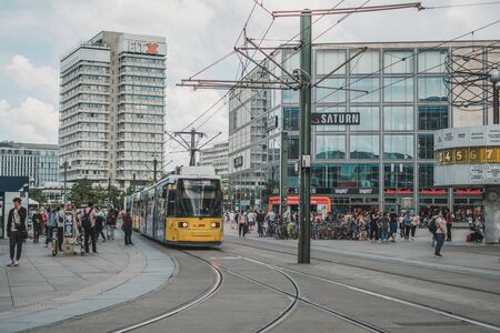 People and tram train on street at Alexanderplatz Square in Berlin city centerのeditorial素材