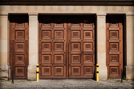 massive wooden gate entrance on building - huge wood doorの写真素材
