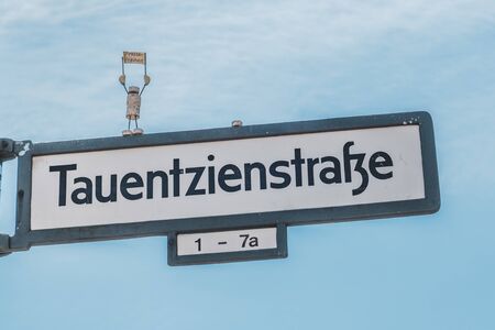 Street sign of the Tauentzienstrasse, with miniature model protesting for freedom of the pressのeditorial素材