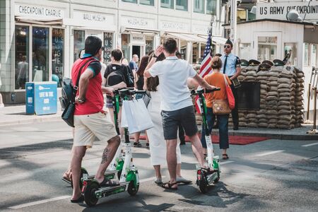 Tourist group riding electric scooter, escooter or e-scooter on street in Berlin, Germanyのeditorial素材