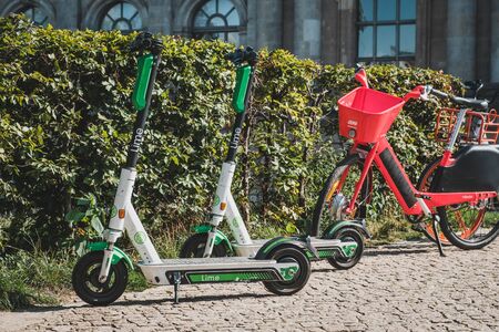 Berlin, Germany - June, 2019: Electric E scooter , escooter or e-scooter and bike sharing bicycle on sidewalk in Berlinのeditorial素材