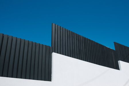 black and white wall and blue skyの写真素材