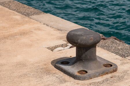 Empty coastal mooring or towing bollard for the boat, yacht or vessel.