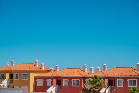 colorful apartment houses with blue sky copy space - real estate exterior