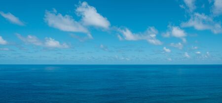 blue sky with clouds over water - ocean horizon , sea backgroundの写真素材