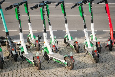 Many Electric E scooters, escooter or e-scooter on sidewalk in Berlin
