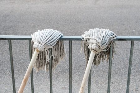 cleaning mop, two cleaning mops hanging to dry