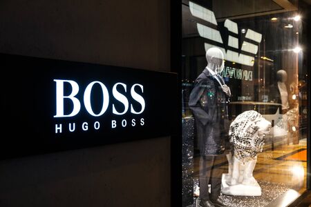Hongkong - Noveber, 2019: Hugo Boss  logo signage on Store facade and shopping window in Hongkongのeditorial素材