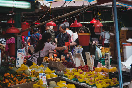 HongKong, China - November, 2019: People buying vegetables and fruits on street food market in HongKongのeditorial素材