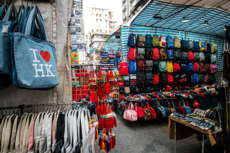 HongKong, China - November, 2019: Bags, backpacks and clothing on street market (Ladie's Market) in Hong Kong, Tung Choi Streetのeditorial素材