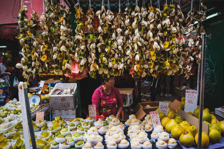 HongKong, China - November, 2019: Woman selling fruits on street food market in Hong Kongのeditorial素材