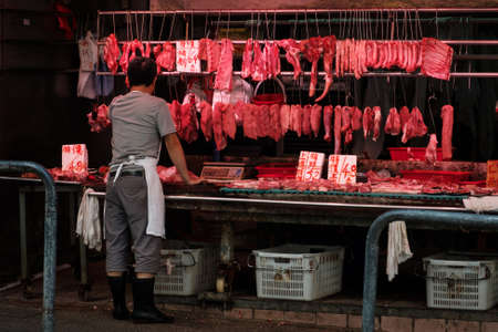 HongKong, China - November, 2019: Butcher selling meat on street market store in Hong Kongのeditorial素材