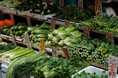 HongKong, China - November, 2019: Salad, spices and vegetables on street food market stand in Hong Kongのeditorial素材